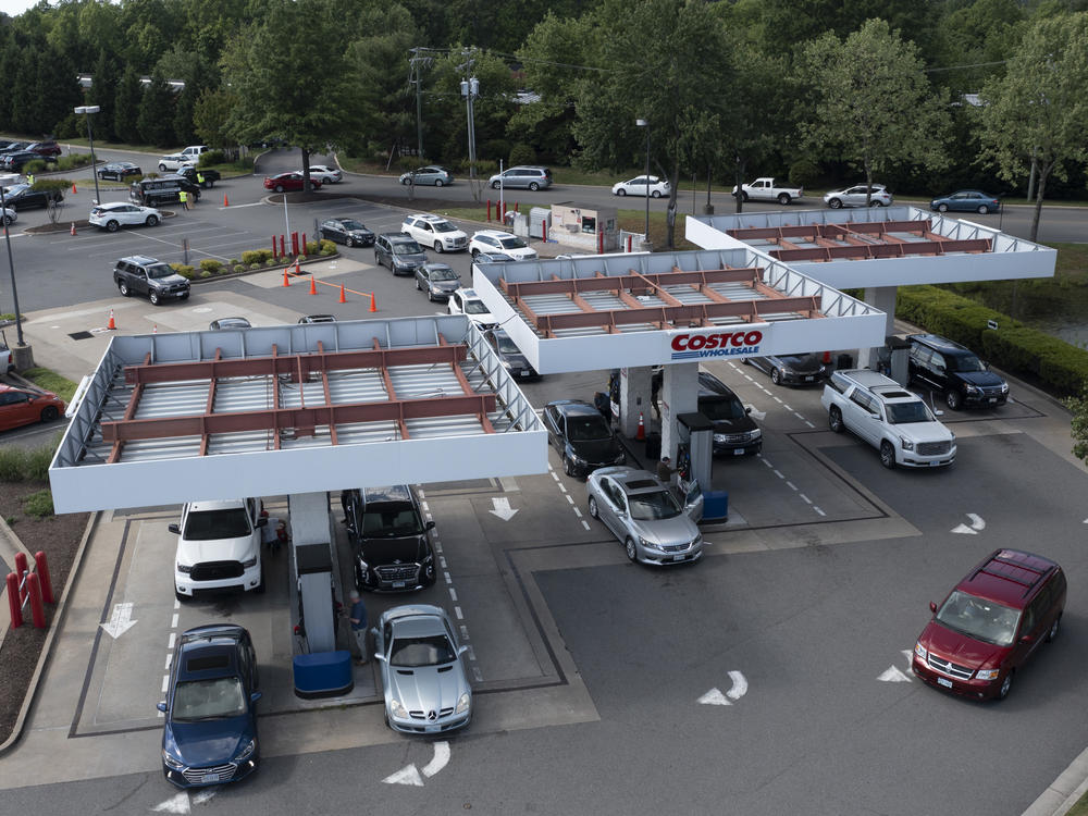 Customers swarm a Costco gas station Tuesday in Richmond, Va., amid fears of a gas shortage. The line at the facility extended around the building.