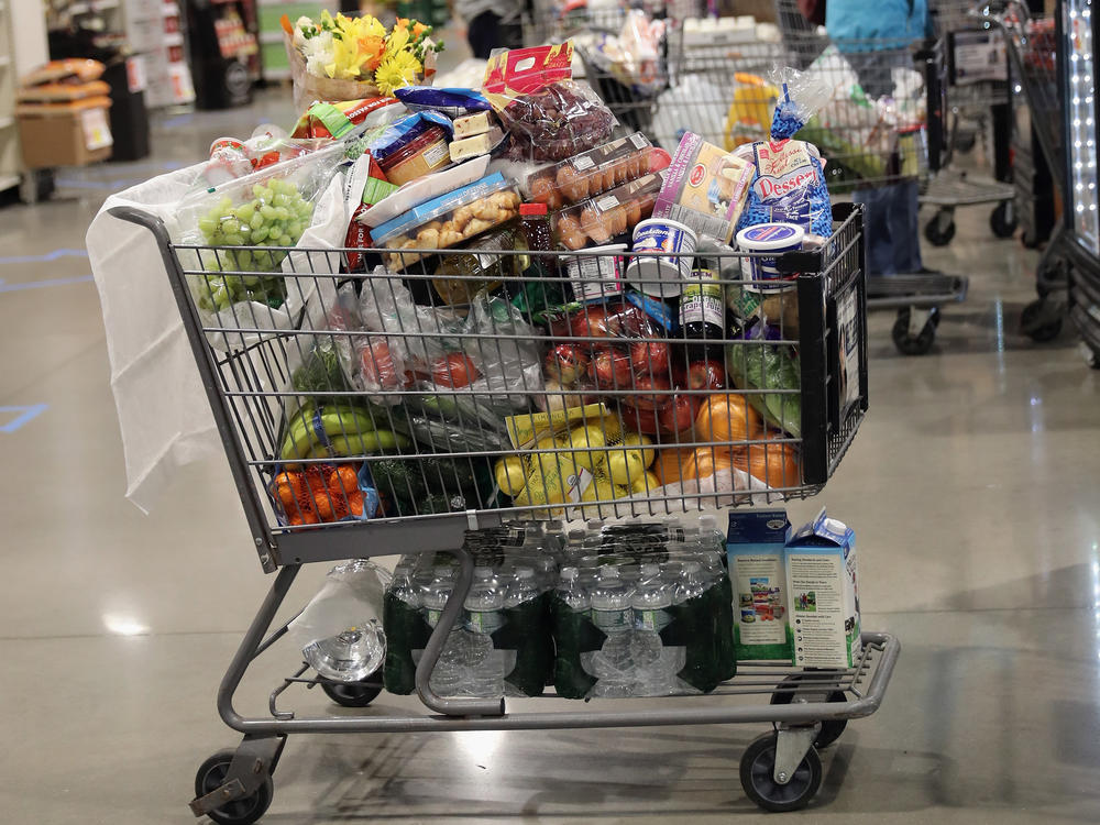 A shopper's cart is full in the checkout line at a ShopRite supermarket in April 2020 in Plainview, N.Y. A year later, prices for most goods have jumped, according to government data, as companies struggle to secure critical raw materials amid supply constraints.