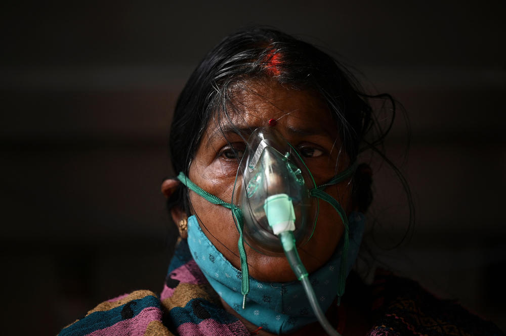 Under a tent installed along a roadside in Ghaziabad, India, a patient breathes with the help of oxygen provided by a gurdwara, a place of worship for Sikhs, amid the coronavirus pandemic on May 2.