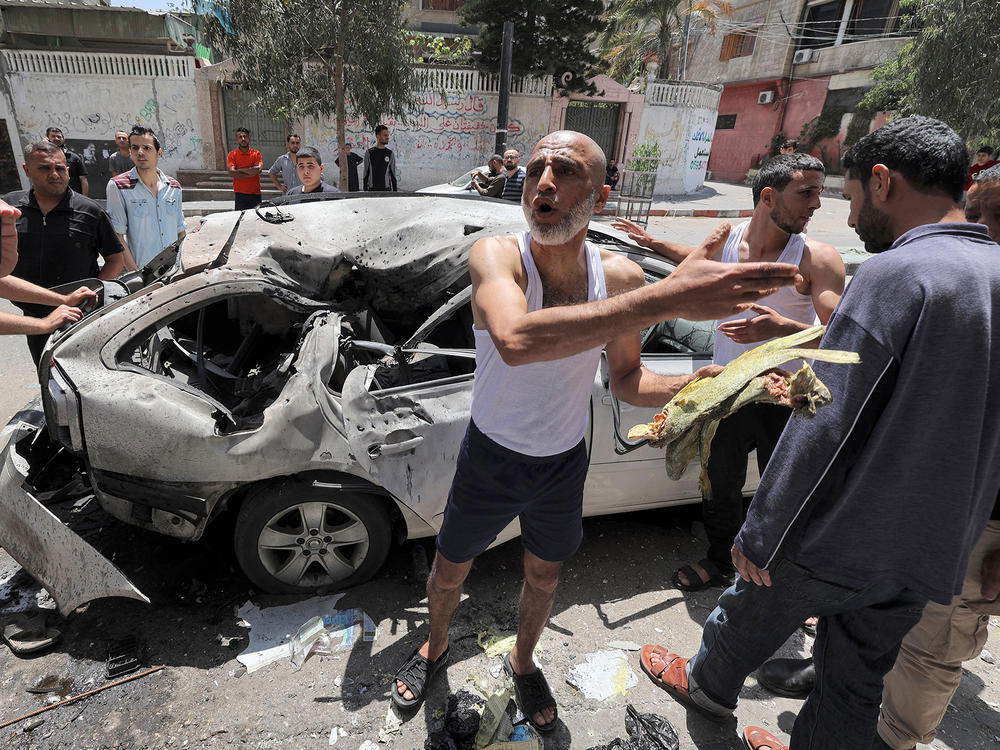 In Gaza City on Wednesday, Palestinians inspect a vehicle destroyed by an Israeli airstrike after the bodies of its passengers and driver were retrieved.