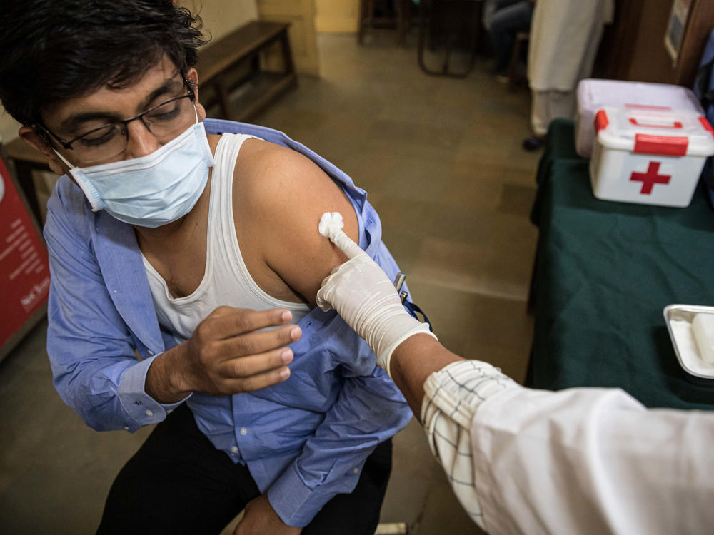 Amit Sonawane, 35, an engineer at a district health office, gets his first vaccine dose in Palghar, India.