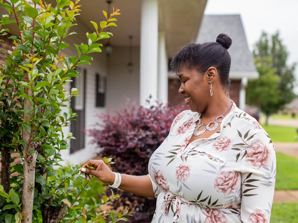 Tia Cunningham says she was able to get out of subsidized housing and use the money as a down payment to buy a house.