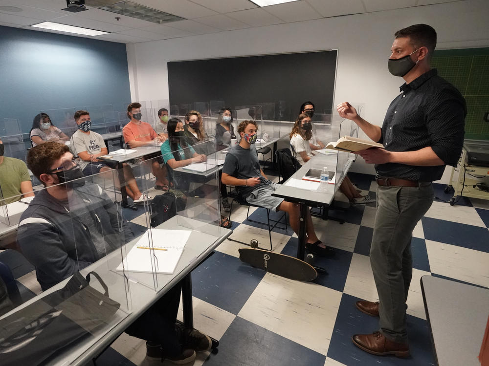 The CDC announced Thursday that fully vaccinated people can safely stop wearing masks indoors and outdoors. Kyle Faircloth teaches a class at Palm Beach Atlantic University in West Palm Beach, Fla., in February.