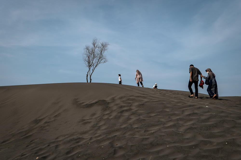 Indonesian Muslims walk after they perform an Eid al-Fitr prayer on the 