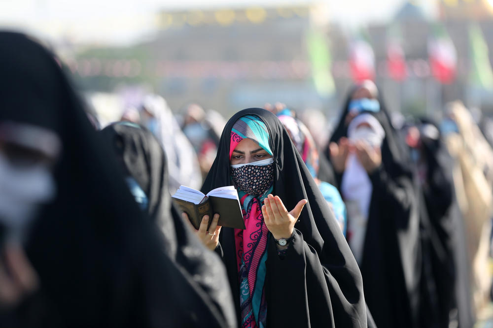 Iranian women wearing protective face masks perform the Eid al-Fitr prayer and pray for Palestinians at Shah Abdol-Azim Shrine amid the coronavirus pandemic in Tehran, Iran on Thursday.
