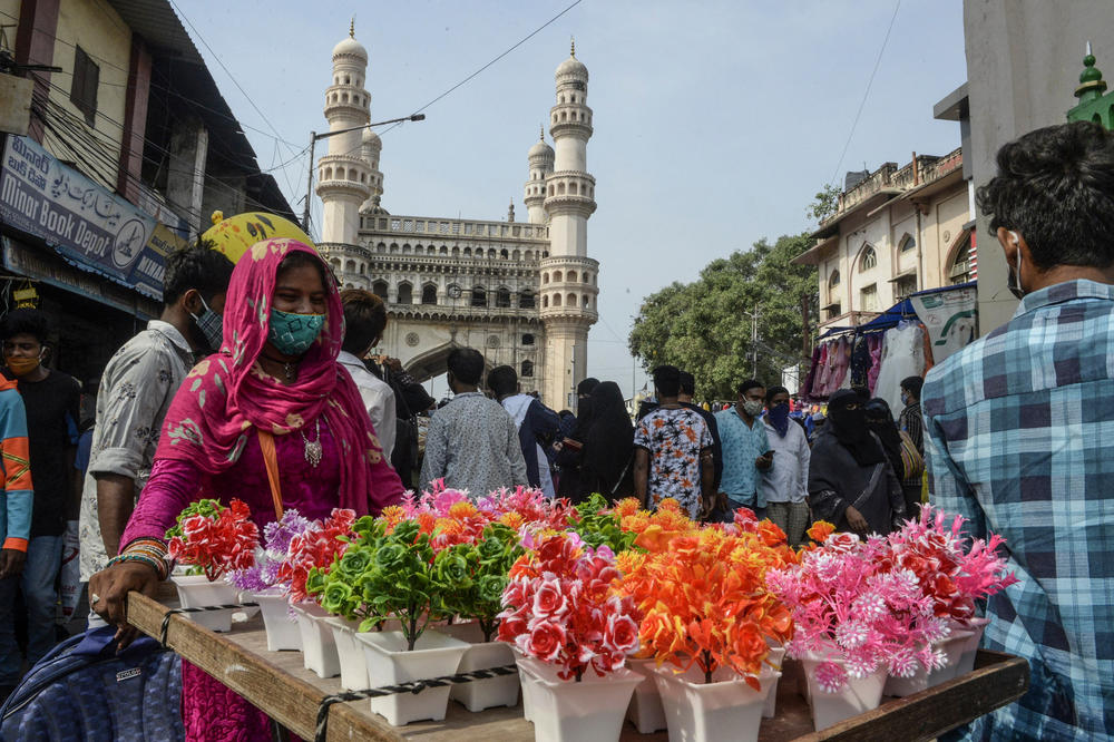 People gather at a market in the old city of Hyderabad, India on the occasion of Eid as the government imposes a 10-day lockdown to curb the spread of the coronavirus on Thursday.