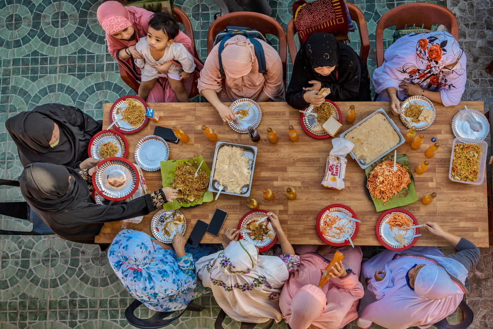 Filipino Muslims eat a meal together as they celebrate Eid at the Garden Mosque in Manila on Thursday.