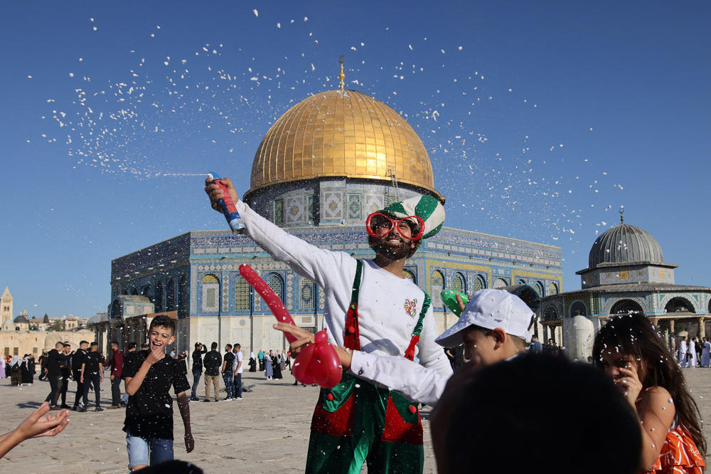 Muslims celebrate in front of the Dome of the Rock mosque in Jerusalem's Old City.