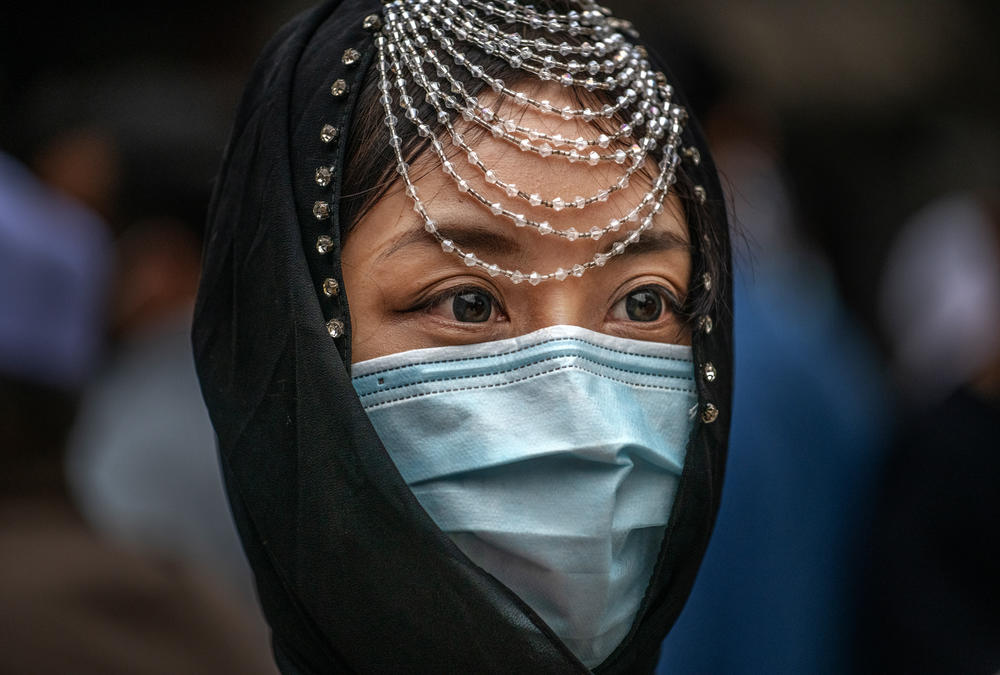 A Hui Muslim woman wears a mask at Eid al-Fitr prayers on Thursday at the historic Niujie Mosque in Beijing, China.
