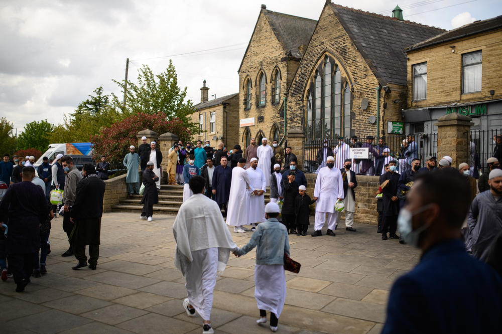 Muslims leave after the Eid al-Fitr prayer at Bradford Central Mosque in Bradford, northern England.