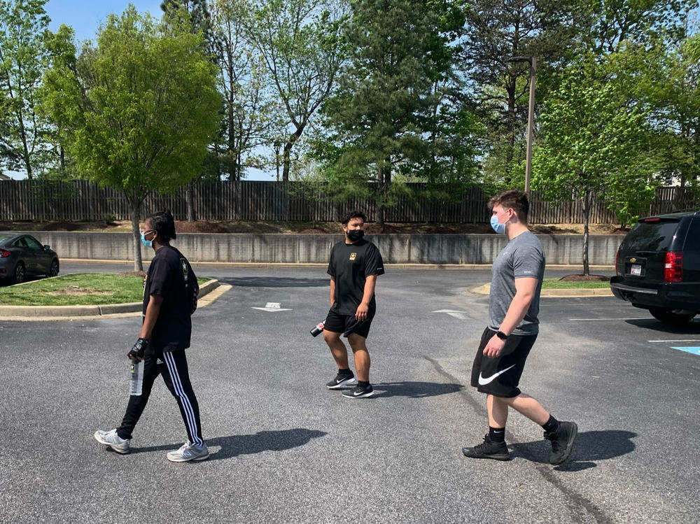 Marcus Robinson (center) wanted to enlist in the Army but was too heavy to qualify for the military's fitness standards. So he started to get in shape — showing up at an Army recruitment office in Waldorf, Md., for weekly workouts in the parking lot.