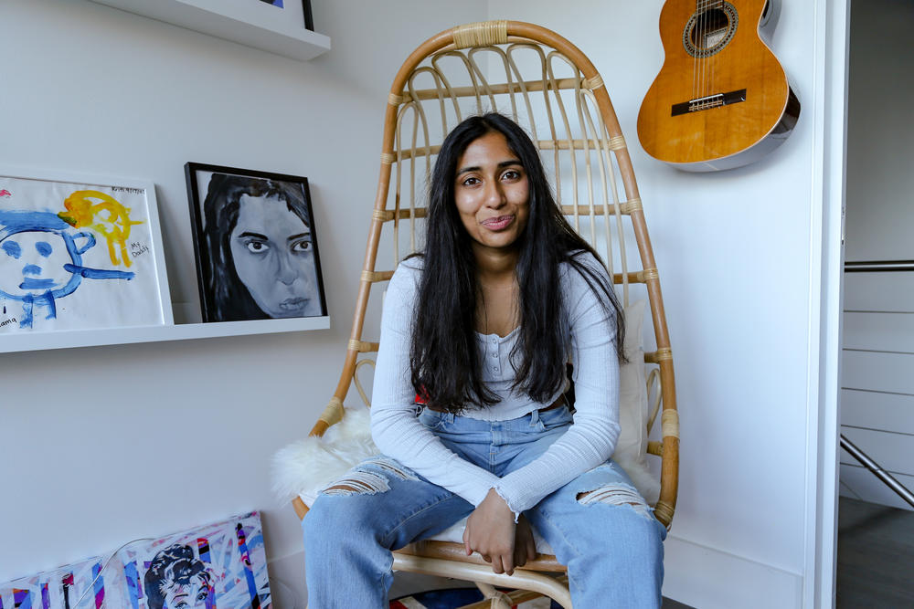 Sarav sits in her study in her family's home.