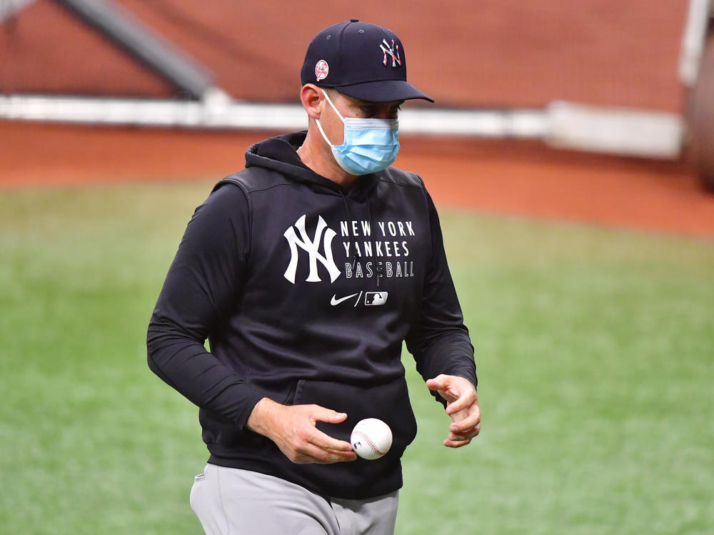 The New York Yankees, including manager Aaron Boone, are back to wearing masks after the team reported eight 