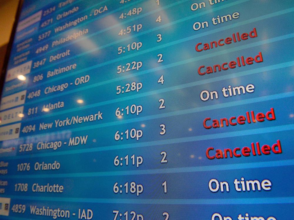 A screen shows canceled incoming flights at T.F. Green International Airport in Warwick, R.I., on March 30, 2020. Consumer advocates and two senators say airlines are sitting on nearly $15 billion in refunds owed to customers for canceled travel.