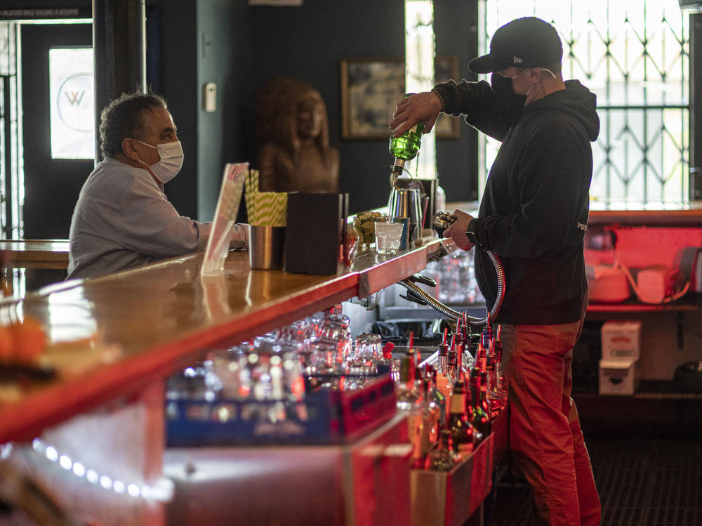 A bartender mixes a drink inside a bar last week in San Francisco. The latest retail sales data out on Friday showed an increase in sales at restaurants and bars as more people venture out amid the continued reopening of the U.S. economy.