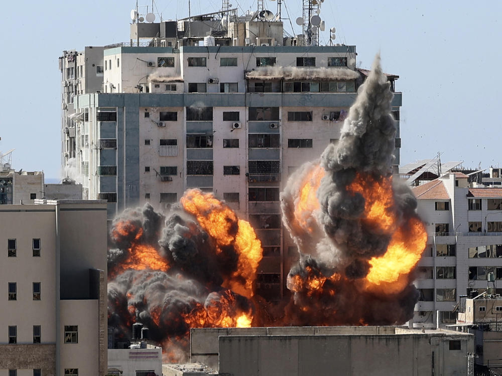 A ball of fire erupts from a building housing various international media, including The Associated Press, after an Israeli airstrike on Saturday in Gaza City. AP staffers and other tenants safely evacuated the building after the Israeli military telephoned a warning that the strike was imminent.