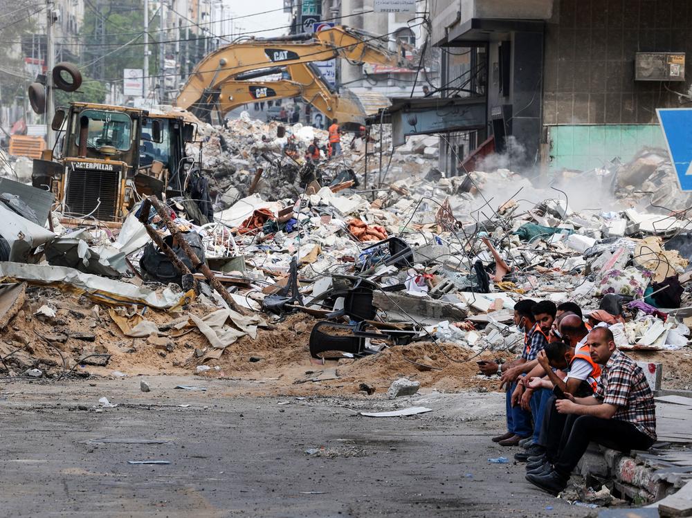An excavator clears the rubble of a destroyed building in Gaza City on Sunday, following Israeli airstrikes.