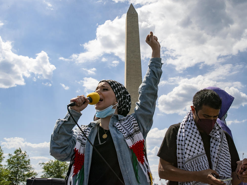 Mariam Abou-Ghazala speaks to protesters and activists near the Washington Monument as part of pro-Palestinian demonstrations around the world on Saturday.