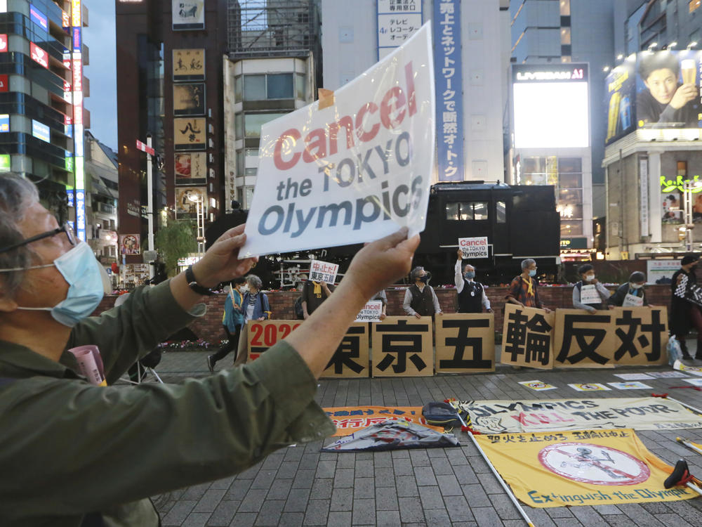 A demonstrator holds a placard during an anti-Olympics demonstration in Tokyo on Monday. A prominent doctors association has joined calls to cancel the Summer Games in Tokyo.