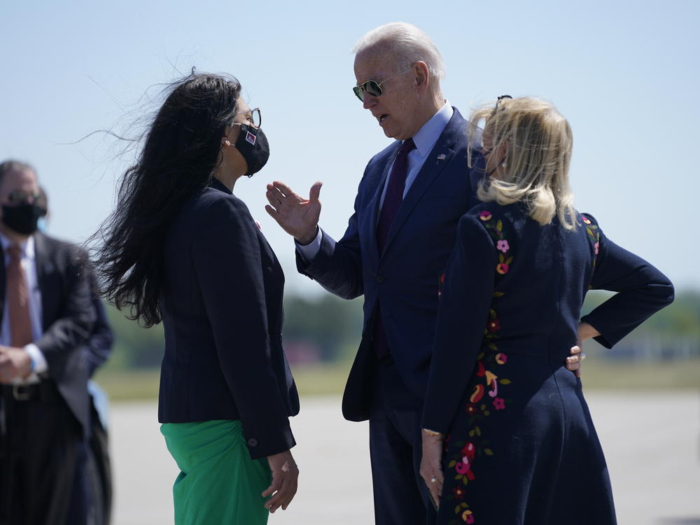 President Biden speaks with Rep. Rashida Tlaib (left) and Rep. Debbie Dingell as he arrives in Detroit on Tuesday.