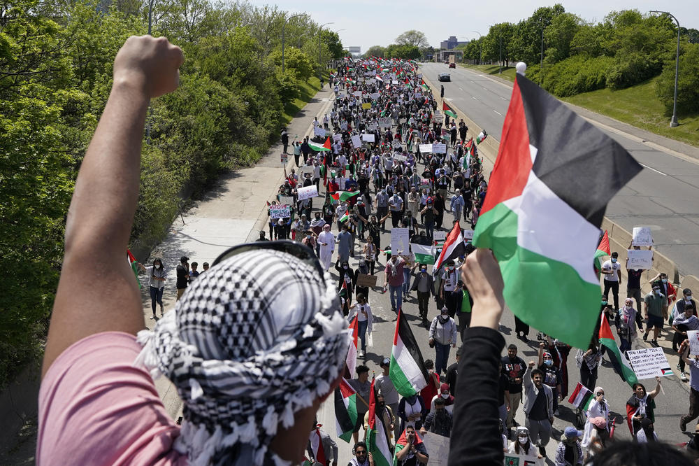 Protesters supporting Palestinians walk down Michigan Avenue in Dearborn on Tuesday, during a visit by President Biden nearby.