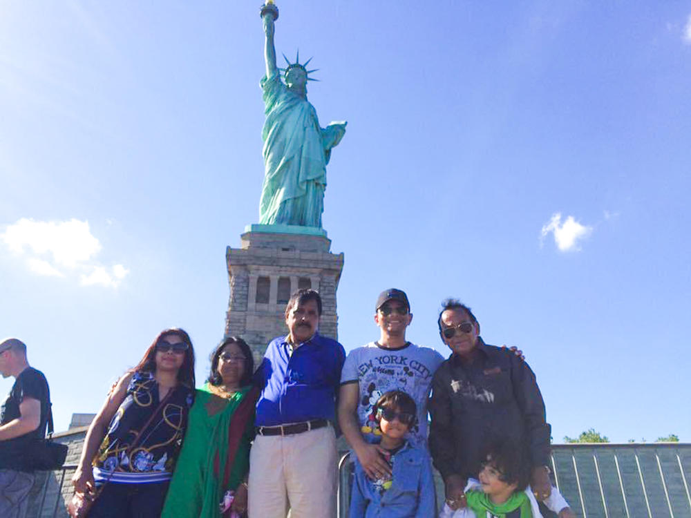 Richa Srivastava (from left); her mother; her father, Sheo Prakash Srivastava; her husband, Shalabh Pradhan; his father, Sudheer Kumar Pradhan; and their children in an undated family photo at the Statue of Liberty.