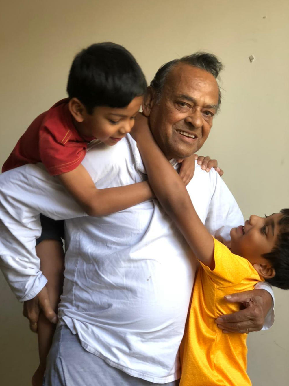 Sudheer Kumar Pradhan with his grandchildren in an undated family photo. He died of COVID-19 on April 21.