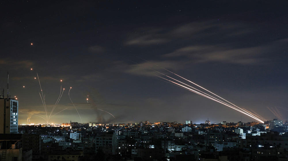 Israel's Iron Dome missile defense system (left) intercepts rockets fired by Hamas from Gaza toward Israel early on May 16. Israel activated the system in 2011 and credits it with stopping many rockets, but some do get through.