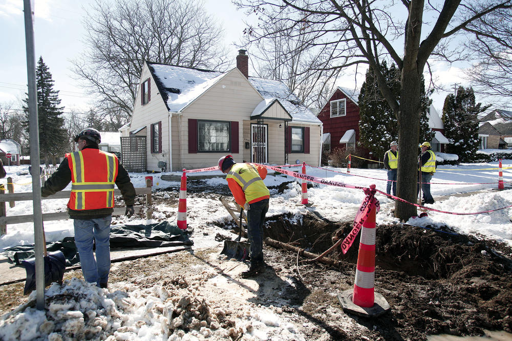 In 2016, city workers prepare to replace the service line at a home in Flint, Mich., where high lead levels were detected.