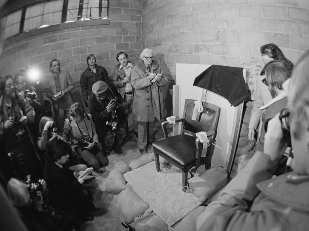 Journalists take photos of the chair in which Gary Gilmore sat facing a firing squad in 1977 in Draper, Utah. The state has carried out all three of the executions by firing squad in the U.S. since the 1970s.