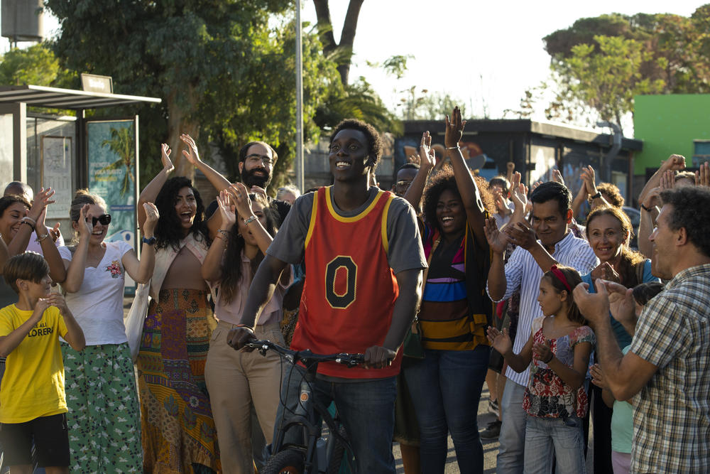 Giuseppe Dave Seke (center) plays a superhero who helps save his neighborhood from gentrification in Netflix's Italian-language series <em>Zero</em><em>.</em> It's Italy's first TV series with a predominantly Black cast.