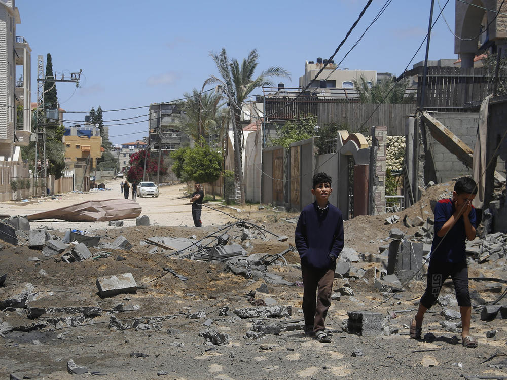 Palestinian children walk past the rubble of a house hit by Israeli airstrikes this week in Beit Lahyia in the northern Gaza Strip.