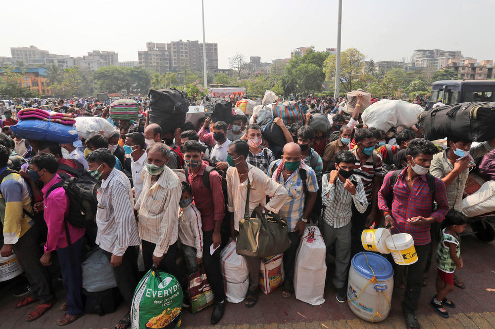 People line up to board trains in Mumbai, India, last month. Migrant workers were swarming rail stations in the country's financial capital to go to their home villages as virus-control measures dried up work in the hard-hit region.