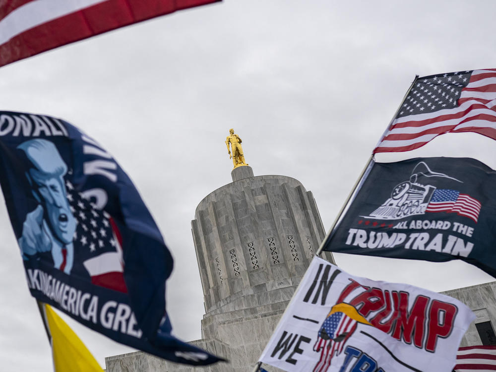 Supporters of then-President Donald Trump wave flags during a Stop the Steal rally outside the Oregon capitol building in Salem on Nov. 14, 2020. Organizers in the state are leading a long-shot push to have conservative Oregon counties become a part of Idaho.
