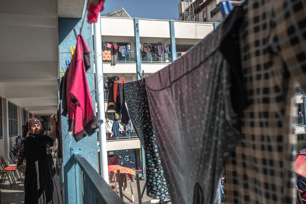 A Palestinian woman hangs up washing Wednesday in a school run by the U.N. Relief and Works Agency, where some families are now living, following Israeli raids on Beit Hanoun in northern Gaza.