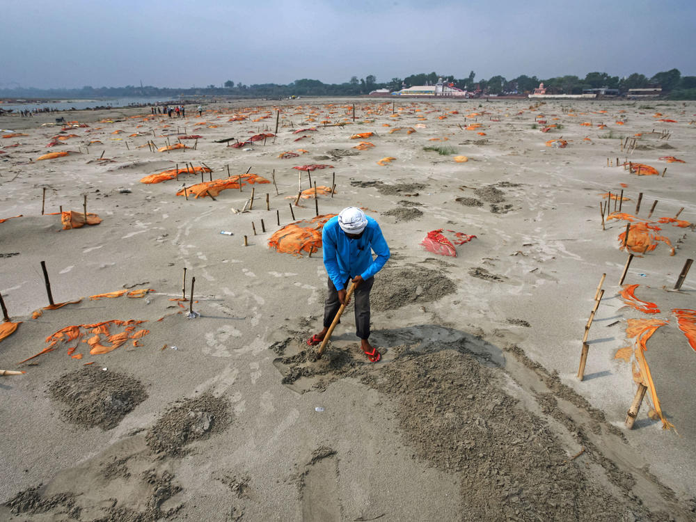 Rains have washed away the top layer of sand of shallow graves at a cremation ground on the banks of the Ganges River in Shringverpur, northwest of Allahabad, Uttar Pradesh, India. Coronavirus testing is limited in parts of rural India, but some of the people buried there are believed to have died of COVID-19.