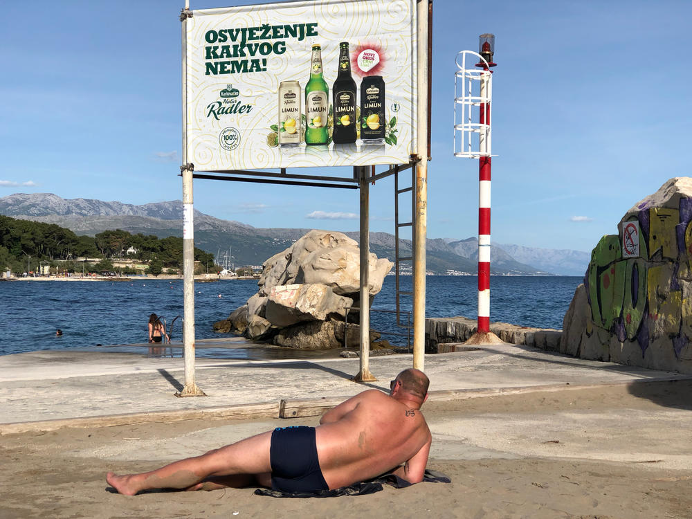 A man rests at Bacvice Beach in the city of Split. The beach has been retaken by local residents, who enjoy bathing in its shallow waters.