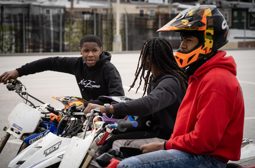 Tony Saunders, 15 (from left), Daron Harrell, 14, and Tathaiso Martin, 18, talk during a brief break in the riding.