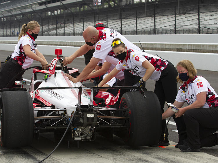 Paretta Autosport crew members work on their car in pit lane at the Indianapolis Motor Speedway during a practice session earlier this week. It could become the first majority-women team to qualify for the Indy 500.