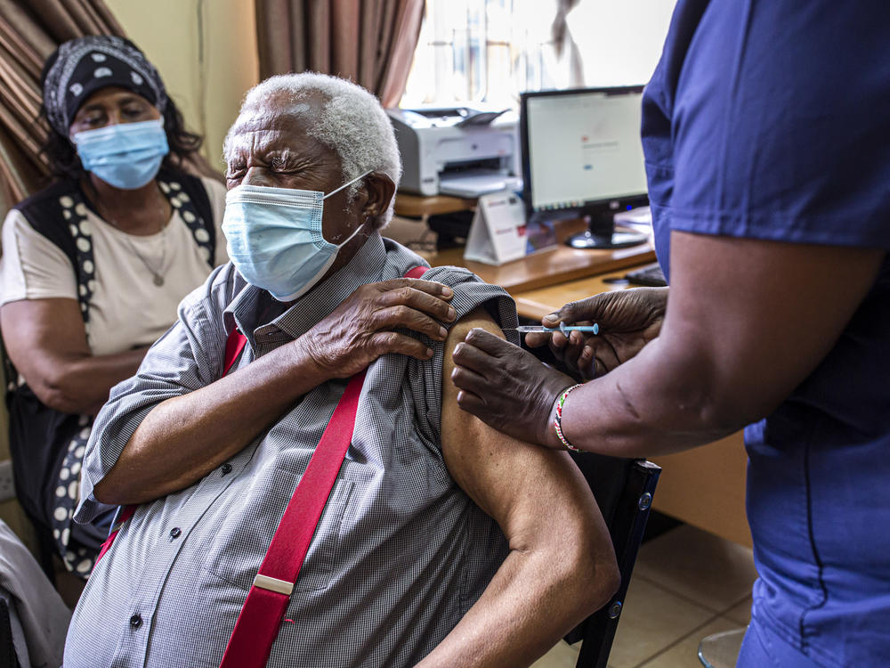 An older person receives their first dose of the AstraZeneca vaccine in Thika, Kenya. The vaccine's manufacturer, Serum Institute of India, announced this week that it will freeze all exports of the vaccine through the end of this year — leaving 20 million people in Africa without a source for their second dose.