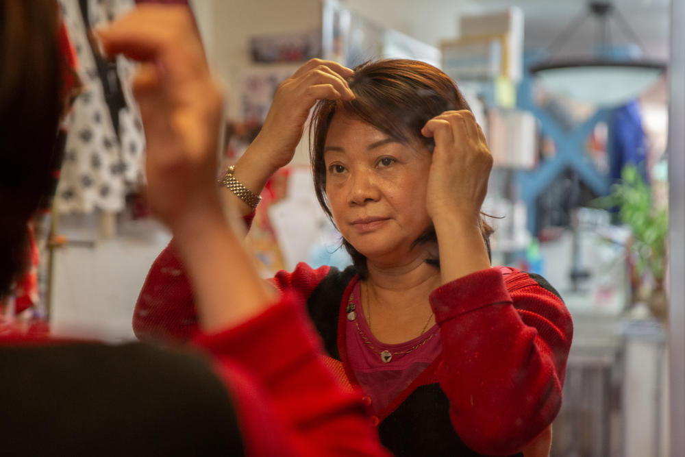Lai adjusts her hair during breaks.