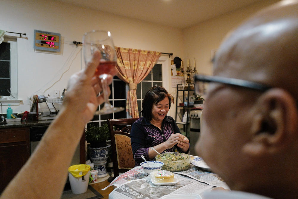 After work, the couple make dumplings together. Here, Lai fills a dumpling with pork and shapes the remaining rounds, as Chan drinks wine and makes jokes.
