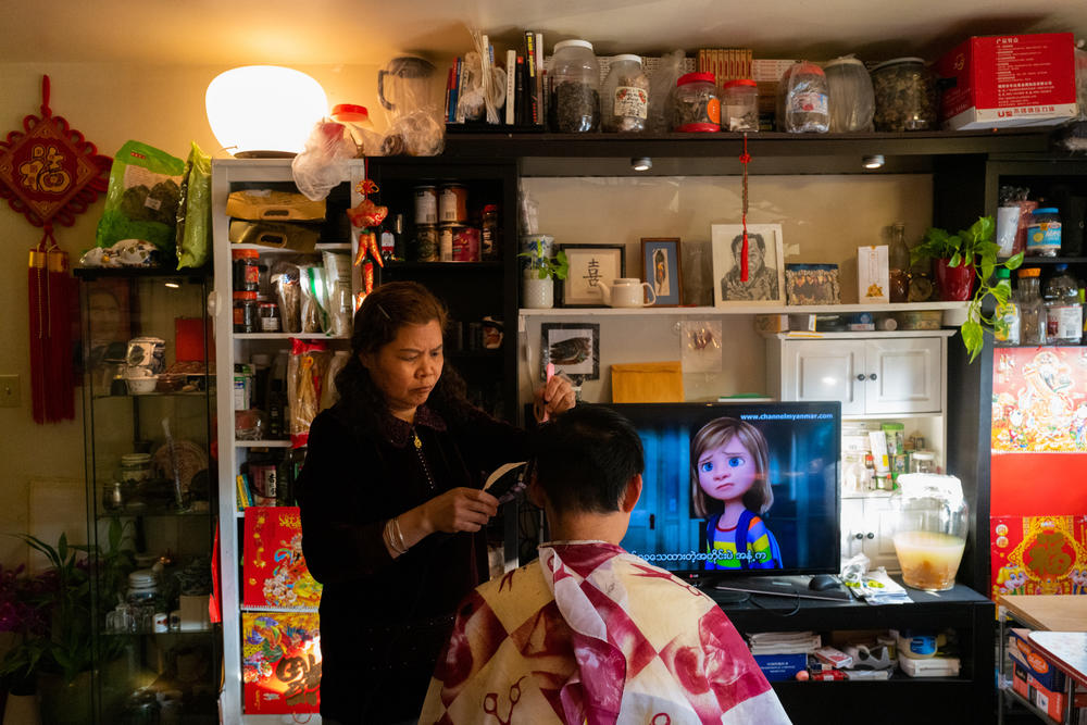 Liang gives her son Jackie a haircut.