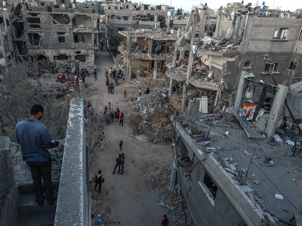 Palestinians inspect the rubble of their destroyed houses in Beit Hanun, northern Gaza Strip, on Saturday. The ceasefire between Israel and Hamas appeared to be holding.