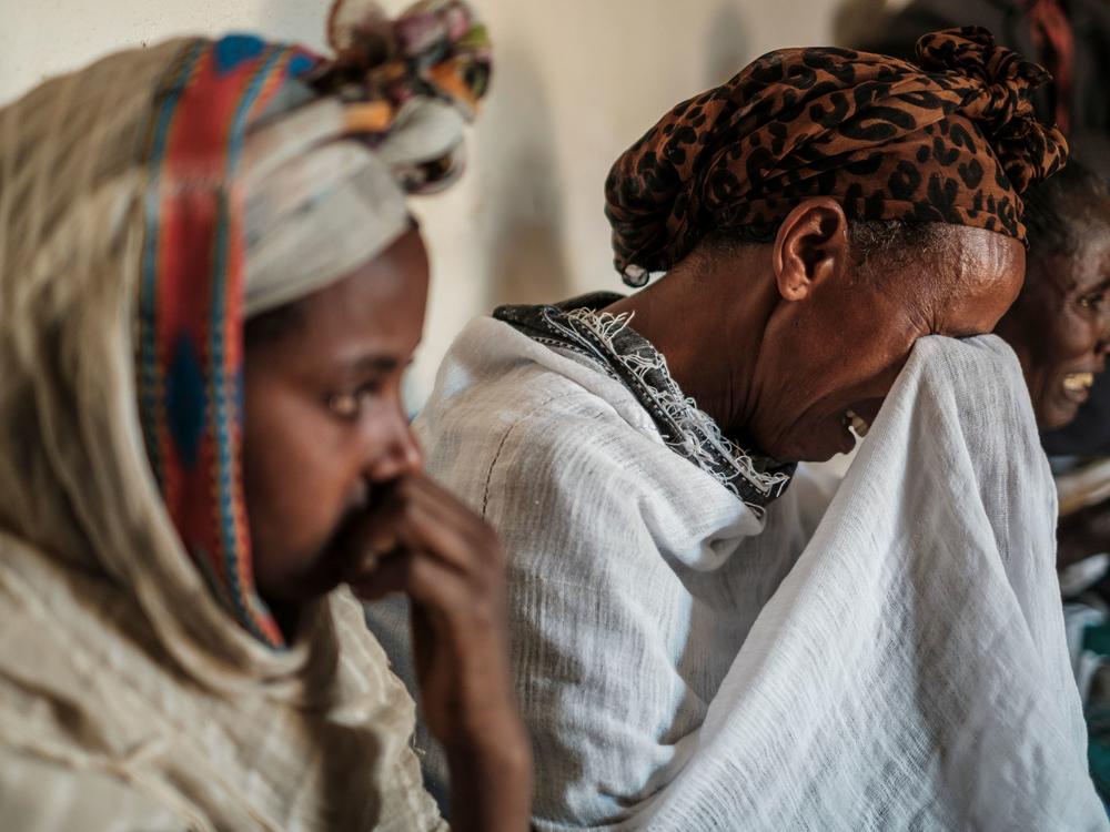 People mourn the victims of a massacre allegedly perpetrated by Eritrean Soldiers, at the house of Beyenesh Tekleyohannes, in the village of Dengolat, North of Mekele, the capital of Tigray. The U.S. announced visa and aid restrictions to Ethiopia due to the months long conflict in the  Tigray region.