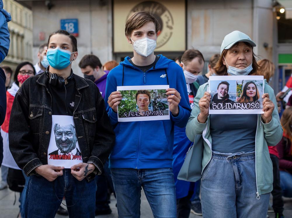 Protesters hold images of Belarus strongman Alexander Lukashenko, Belarus opposition activist Roman Protasevich and Protasevich's partner Sofia Sapega during a demonstration of Belarusians living in Poland and Poles supporting them in front of European Commission office in Warsaw on Monday.