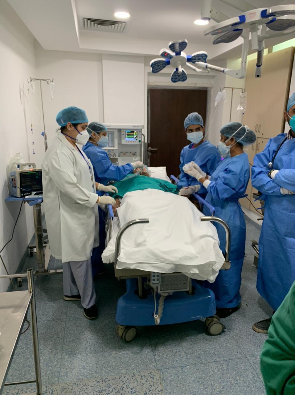 Dr. Rimy Dey (left) treats COVID-19 patients in the emergency room of a private hospital in Gurugram, a suburb of New Delhi.