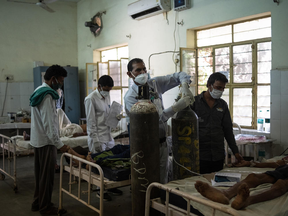 Medical attendant Gurmesh Kumawat prepares to administer supplemental oxygen to a coronavirus patient in the emergency ward at the BDM Government Hospital in mid-May in Kotputli, India.