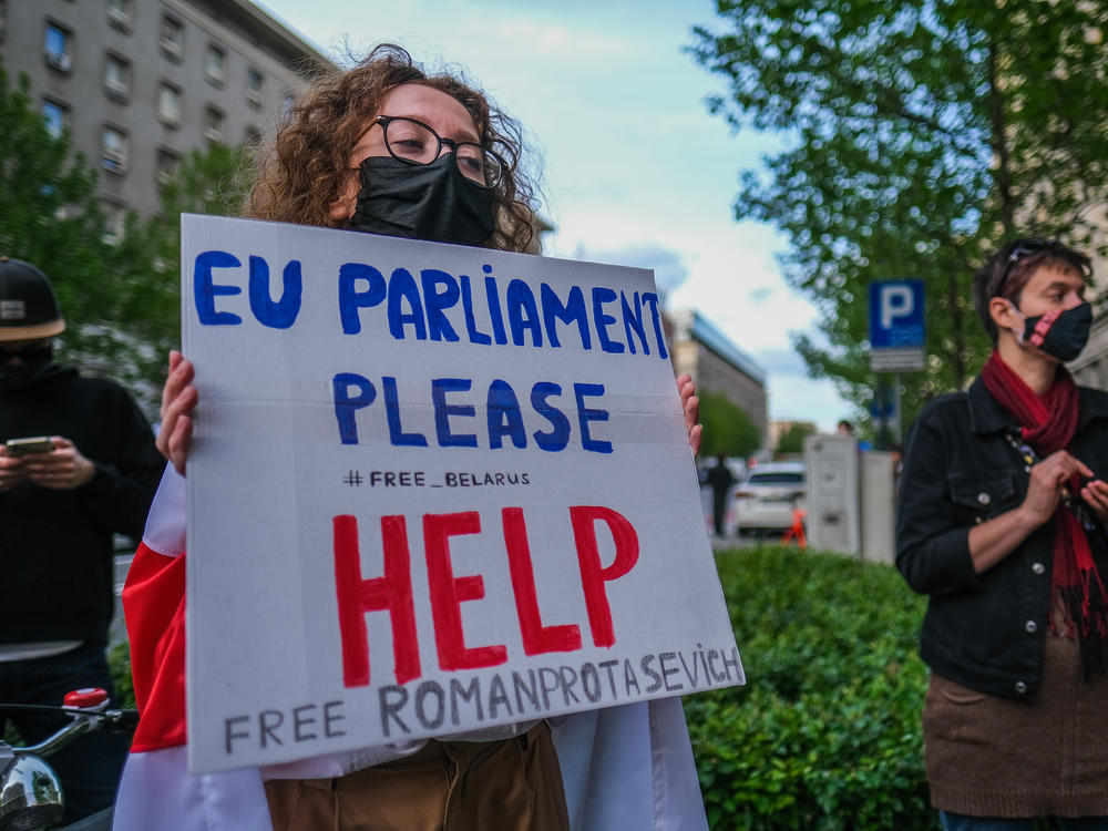 A woman holds a banner during a protest against the detention of the Belarusian journalist Roman Protasevich in front of the European Commission representative office on May 24 in Warsaw, Poland.