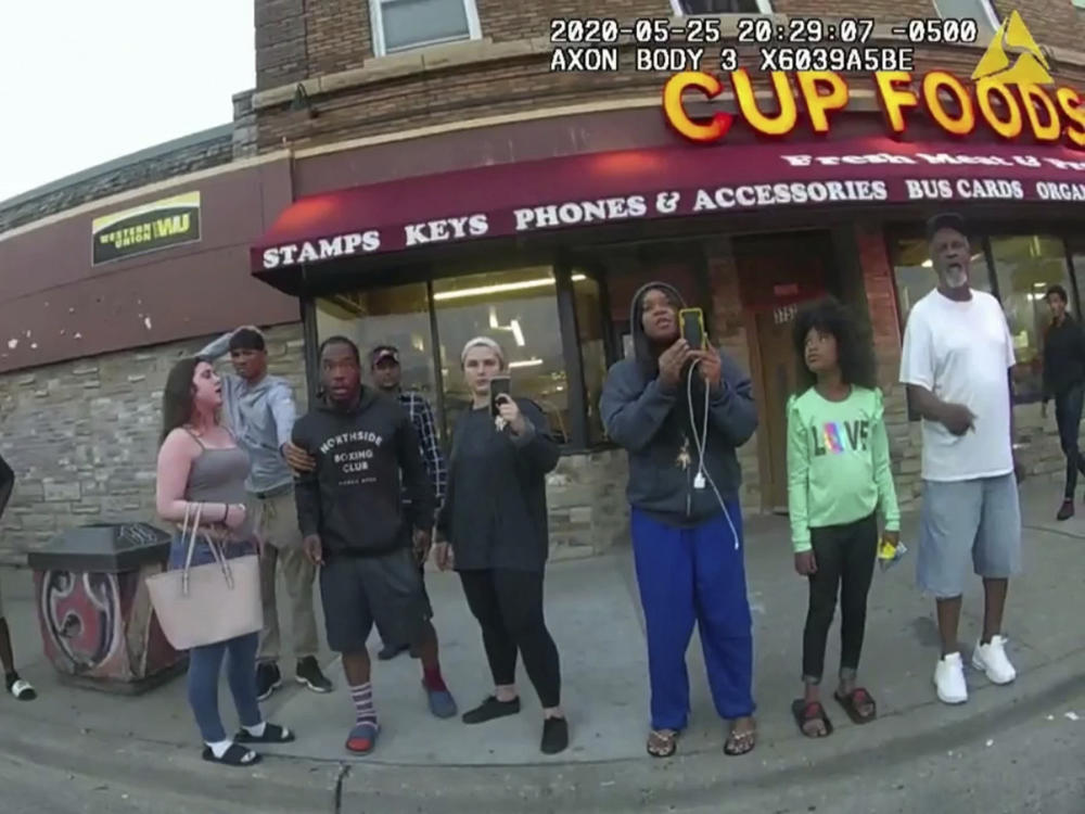 This image from a police body camera shows bystanders including Darnella Frazier (third from right) as Derek Chauvin, who was a police officer at the time, pressed his knee on George Floyd's neck in Minneapolis.